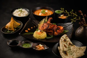 Premium Indian and Asian private chef menu with tandoori chicken, basmati rice, naan bread, samosas and traditional sauces presented in elegant Japanese-style fine dining plating.