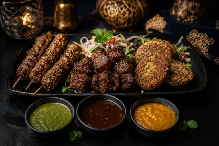 Alt Text Luxury tandoori starter platter featuring lamb shish kebab, beef boti tikka, shami kebab, and homemade mint, tamarind, and mango chutneys, served by a private chef in Spain.